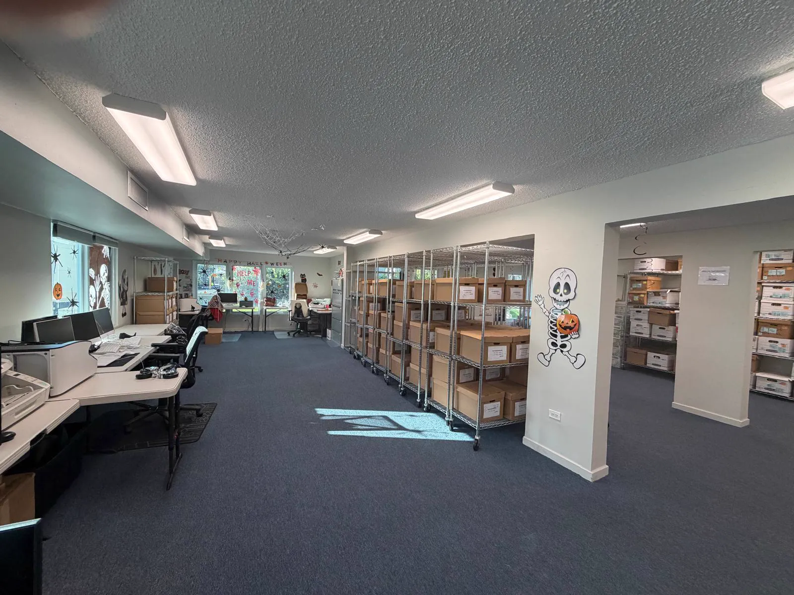 DCS operations floor with workstations and shelving full of labeled archive boxes